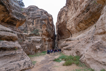 Toursts explore ancient tombs in Little Petra, Jordna