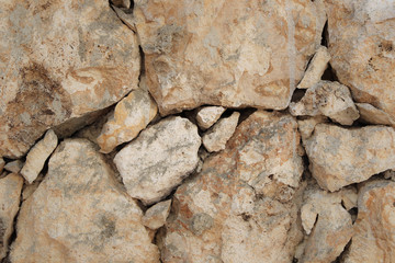 Stone wall of warm tones background