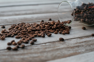 coffee beans spilled on wooden background