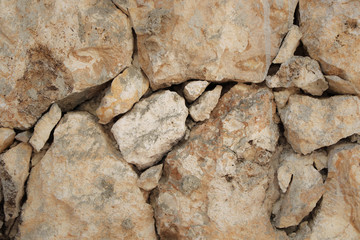 Stone wall of warm tones background