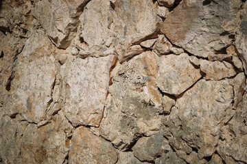 Stone wall of warm tones background