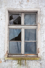 Fototapeta na wymiar broken glass in the window of an abandoned house