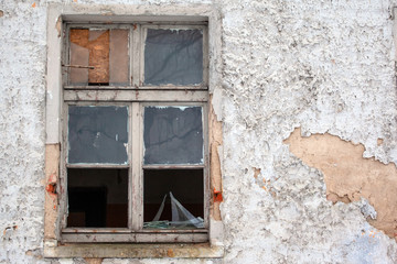 Obraz na płótnie Canvas broken glass in the window of an abandoned house
