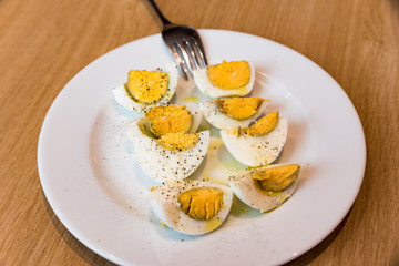 Boiled eggs with salt pepper and olive oil