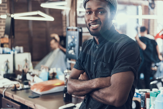 Coiffeur looking at camera and smiling wide