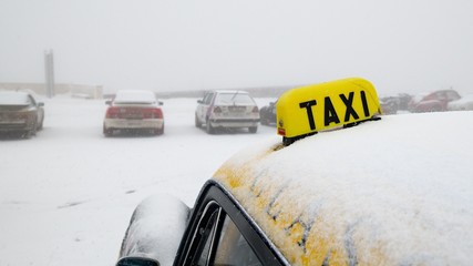 classic cars in the snow. Snow-covered cars parking taxi