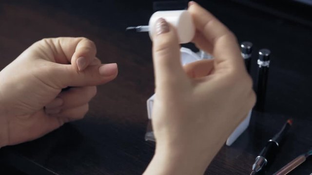 the manicurist treats the nail to herself