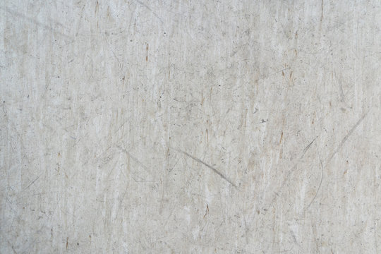 Beige Used Linoleum Tile With Strokes And Scratches Of Black Rubber Soles In A Workroom, Top View