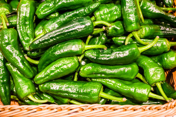 Vegetables in supermarket. Hot green pepper in a basket. Bright colors. Spices, natural product. Background.