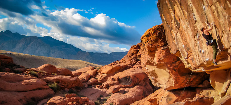 man climbs red rock canyon in Nevada