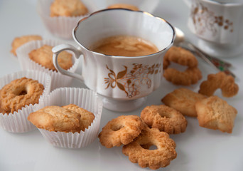 porcelain cup of coffee and crumbly shortbread still life background