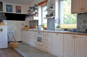 Interior of kitchen in scandinavian style with wooden white furniture