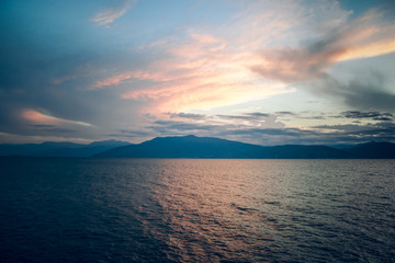soft focus and fuzzy abstract clear morning scenic landscape with sea bay shoreline water surface and mountain background silhouettes 
