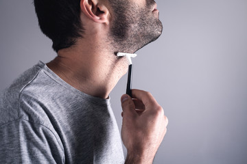  Caucasian man shaving beard razor blade.