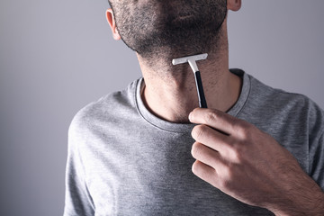  Caucasian man shaving beard razor blade.