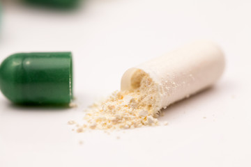 Composition with colorful pills and broken capsules