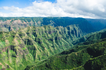 Fototapeta na wymiar Aerial voew of the typical abrupt mountain ranges in Kauai, US