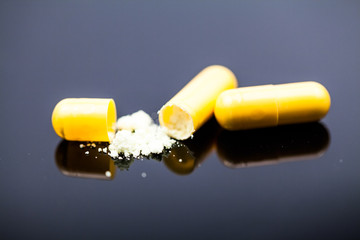 Composition with colorful pills and broken capsules