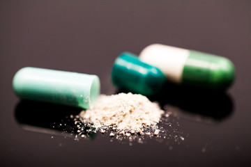 Composition with colorful pills and broken capsules