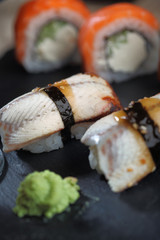 Sashimi sushi set with Philadelphia roll sushi on black slate plate background.Nigiri.Closeup.