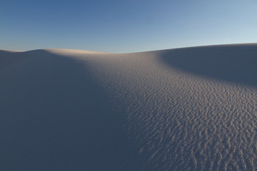 Global warming concept. Sand dunes under evening sunset sky at drought desert landscape