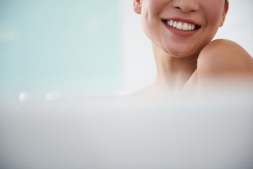 Close up cheerful smiling asian lady in bath