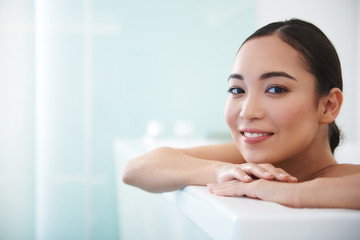 Obraz na płótnie Canvas Relaxed asian lady enjoy spa procedure in bath