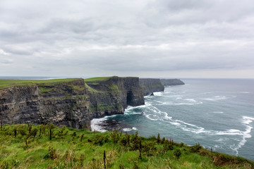 Fototapeta na wymiar Ireland countryside tourist attraction in County Clare. The Cliffs of Moher and castle Ireland. Epic Irish Landscape UNESCO Global Geopark the wild atlantic way