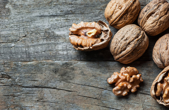 whole big peeled walnut kernel with thin shell on wooden background. healthy food for brain. Fresh walnuts  background nut concept