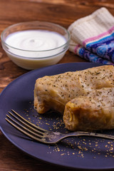 Stuffed cabbage rolls with sour cream on plate