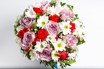 Beautiful designer bouquet of flowers in a beautiful cramped blue bucket.Isolated on a white background.Top view.