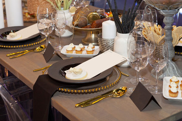 Close up of a fully set banquet table with brown and earth tones