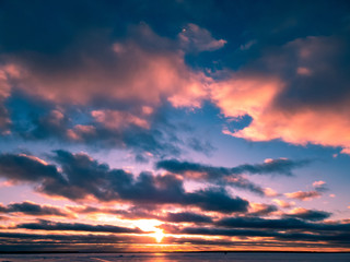 Сlouds in winter on the horizon of a frozen lake.