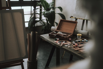 Art studio at daytime with art supplies on the table