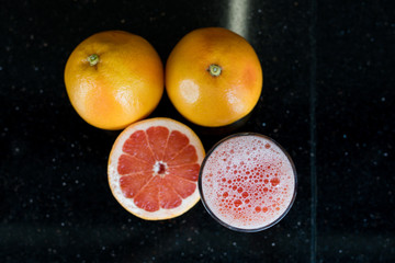 Fototapeta na wymiar A glass of Grapefruit juice and grapefruit slices. Multivitamin, vitamin c