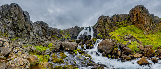 Fototapeta na wymiar Panoramic view of wilderness of fjord landscape and Selbrekkufoss waterfall near Seydisfjordur on Iceland, summer time