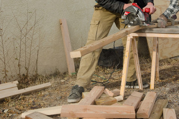 Circular Saw Teamwork Cutting Wood Sawhorse