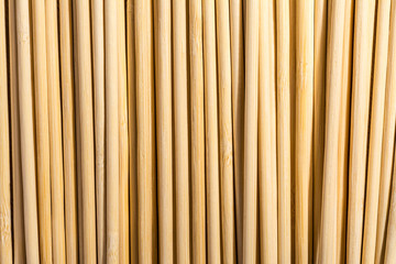 Round wooden sticks background. Close-up Wall Pattern
