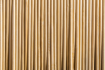 Round wooden sticks background. Close-up Wall Pattern