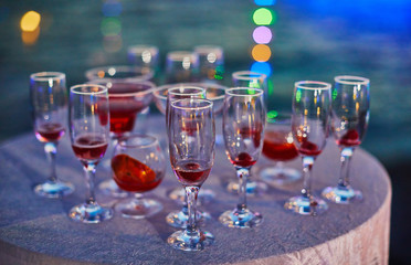 Many different cocktail glasses at sunset sea party