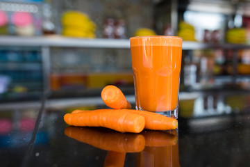 Glass of carrot juice and carrots