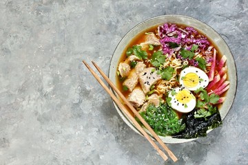 Asian ramen soup is beautiful with beef brisket, purple Peking cabbage, watermelon radish and algae. Asian cuisine. copy space. place for text. top view