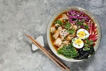 Asian ramen soup is beautiful with beef brisket, purple Peking cabbage, watermelon radish and algae. Asian cuisine. copy space. place for text. top view