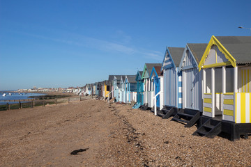 Boats and beach huts on Thorpe Bay beach, Essex, England