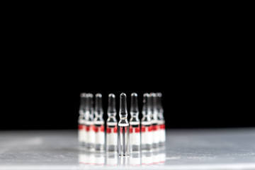 Of the medication vial. Glass ampoules with medicine. Fluid medication standing in a row