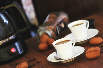 Sweet cookies shaped as cofee beans served with coffee cup