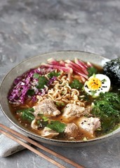 Asian ramen soup is beautiful with beef brisket, purple Peking cabbage, watermelon radish and algae. Asian cuisine. copy space. place for text. 