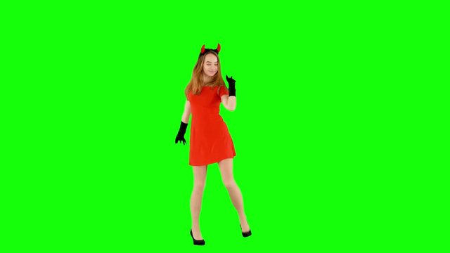 Funny Young Girl Wearing Halloween Devil Costume Dancing on Green Screen
