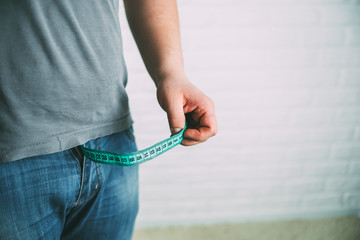 Guy measures penis size with tape measure or tape measure