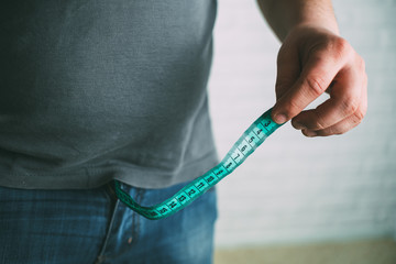 Guy measures penis size with tape measure or tape measure